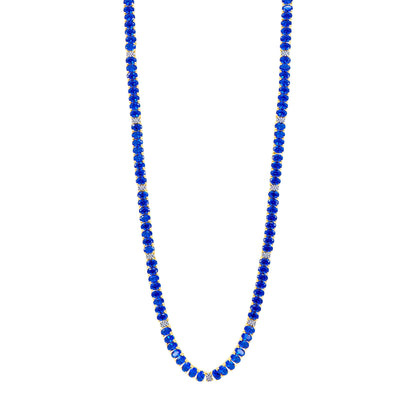 The Midnight Tri-Tone Twilight Oval Station Tennis Necklace by Midnight showcases deep blue beads alternating with 14K matte gold spacers, creating an elegant and evenly spaced design. The uniformly shaped blue beads are beautifully complemented by the small gold spacers, all set against a white background.